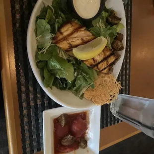 Caesar salad with salmon and a side of stewed tomatoes. Delicious!