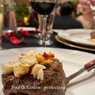 a plate of food and a glass of wine