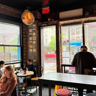 people sitting at tables in a restaurant