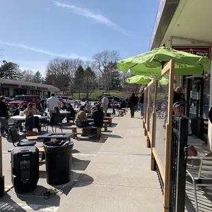 a group of people sitting outside a restaurant