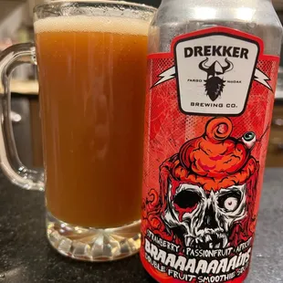 a glass of beer and a can of dreiker