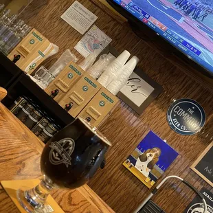 a glass of beer on a bar