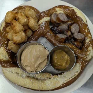 Brats &amp; Tots Pretzel.  Enjoy with two dipping sauces - housemade beer cheese and German mustard.