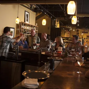 a group of people sitting at a bar