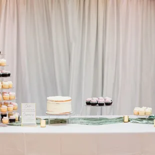 a wedding cake and cupcakes