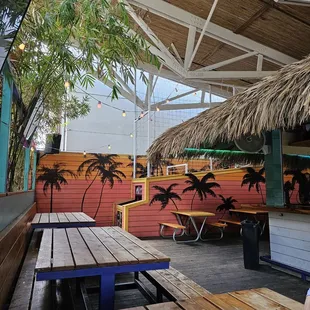 a patio area with tables and chairs
