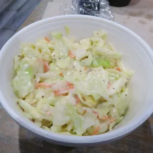 a bowl of coleslaw on a table