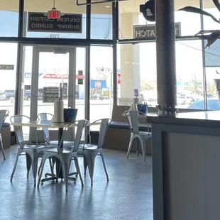 the inside of a restaurant with tables and chairs