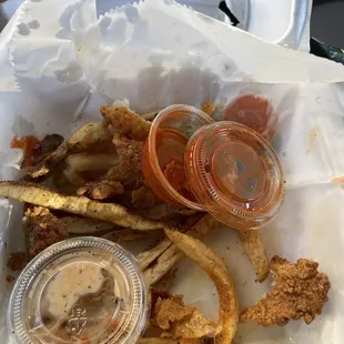 Two fish and fries with hot sauce