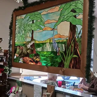 a man sitting in front of a stained glass window