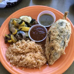 Chicken fried brisket stuffed Chile rellano with green and red sauce, rice &amp; grilled veggies.