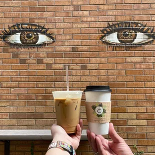 a brick wall with eyes painted on it