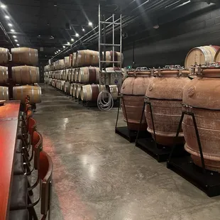 rows of wine barrels in a winery