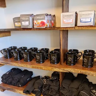 a shelf of coffee mugs