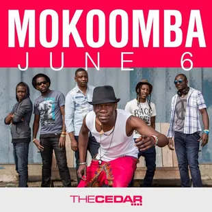 a group of men standing in front of a building