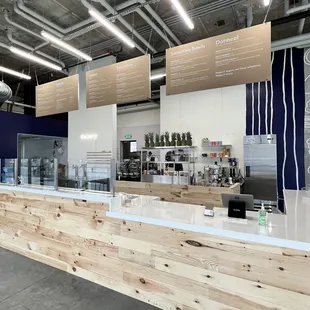 a restaurant counter with a wooden countertop