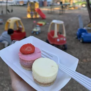 a plate of cheesecakes and strawberries