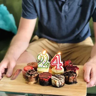 a man holding a birthday cake