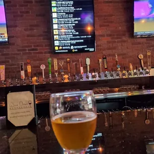 a glass of beer on the bar