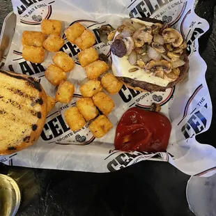 Mushroom Swiss burger with tots