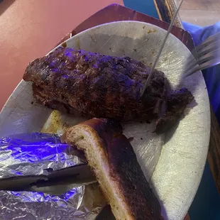 a plate of meat and fries