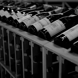 a row of wine bottles on a rack