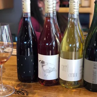 a selection of wines and a glass of wine