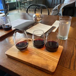three glasses of wine on a cutting board
