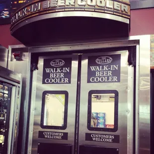 two beer coolers and a sign