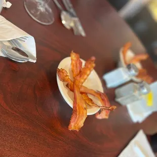 a plate of bacon on a table