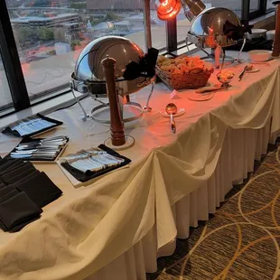 a buffet table with a view of the city