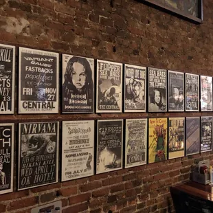 a brick wall with posters on it