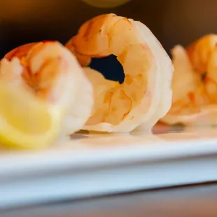 shrimp and lemon on a white plate