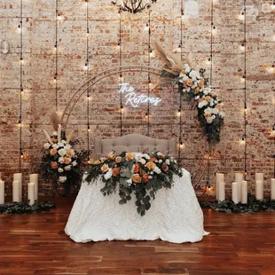 Transition from altar set-up to sweetheart table, floral by in-house florist Hand Creations Floral. Neon sign provided by my husband and I