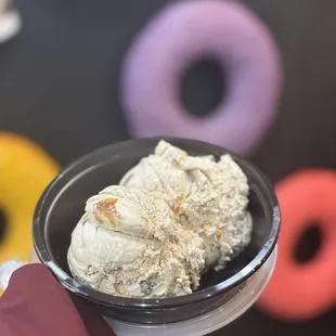 a person holding a bowl of ice cream