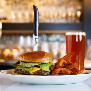 The Chalkboard burger - bacon + onion marmalade, aged sharp cheddar, arugula, brioche bun, house fries