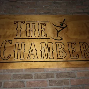 a sign on a brick wall