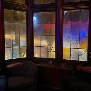 a stained glass window in a dark room