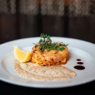 Delicious housemade crab cakes with ancho chili rémoulade, fresh corn &amp; salsa negro