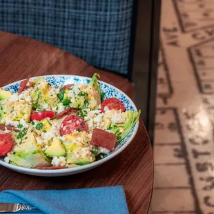 Our Little Gem Caesar Salad with tender butter lettuce, garlic croutons, campari tomatoes, shaved Parmesan, buttermilk Caesar dressing.