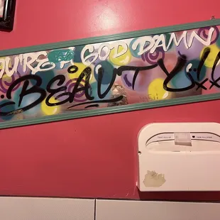 Body positive message in womens bathroom