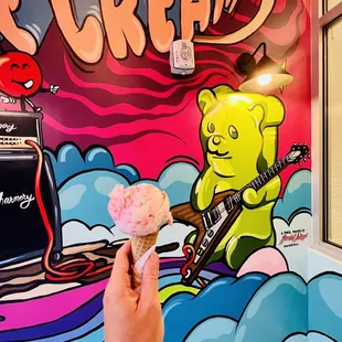 a hand holding an ice cream cone