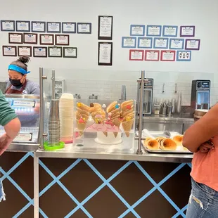 a man and a woman standing in front of a counter