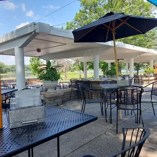 a patio with tables and umbrellas