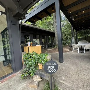 Hostess stand passed bakery to left and outdoor seating to right