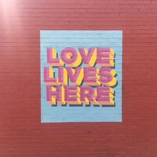 love lives here on a brick wall