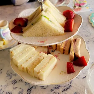 a plate of sandwiches and strawberries