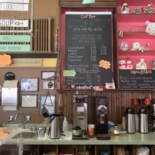 a coffee shop with a menu on the wall