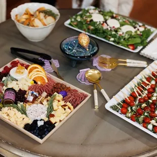 Cheese board, caprese skewers, salad