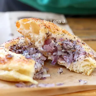 Inside of Onion Poppy Bialy ($3.25) - it&apos;s good! I like the chewy sourdough dough. The onions are quite sweet.